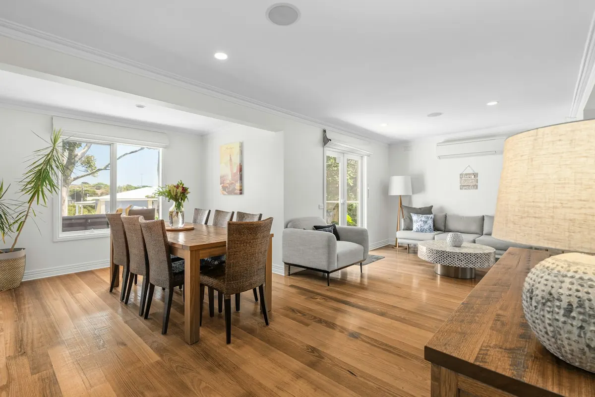 Restored open-plan living and dining room with hardwood floors